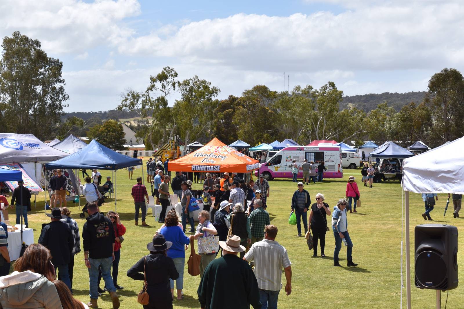 Crowds and vendors at Wandering Fair 2025 with food stalls, local displays and community activities across the oval, supported by event connectivity and vendor WiFi by CRISP Wireless..