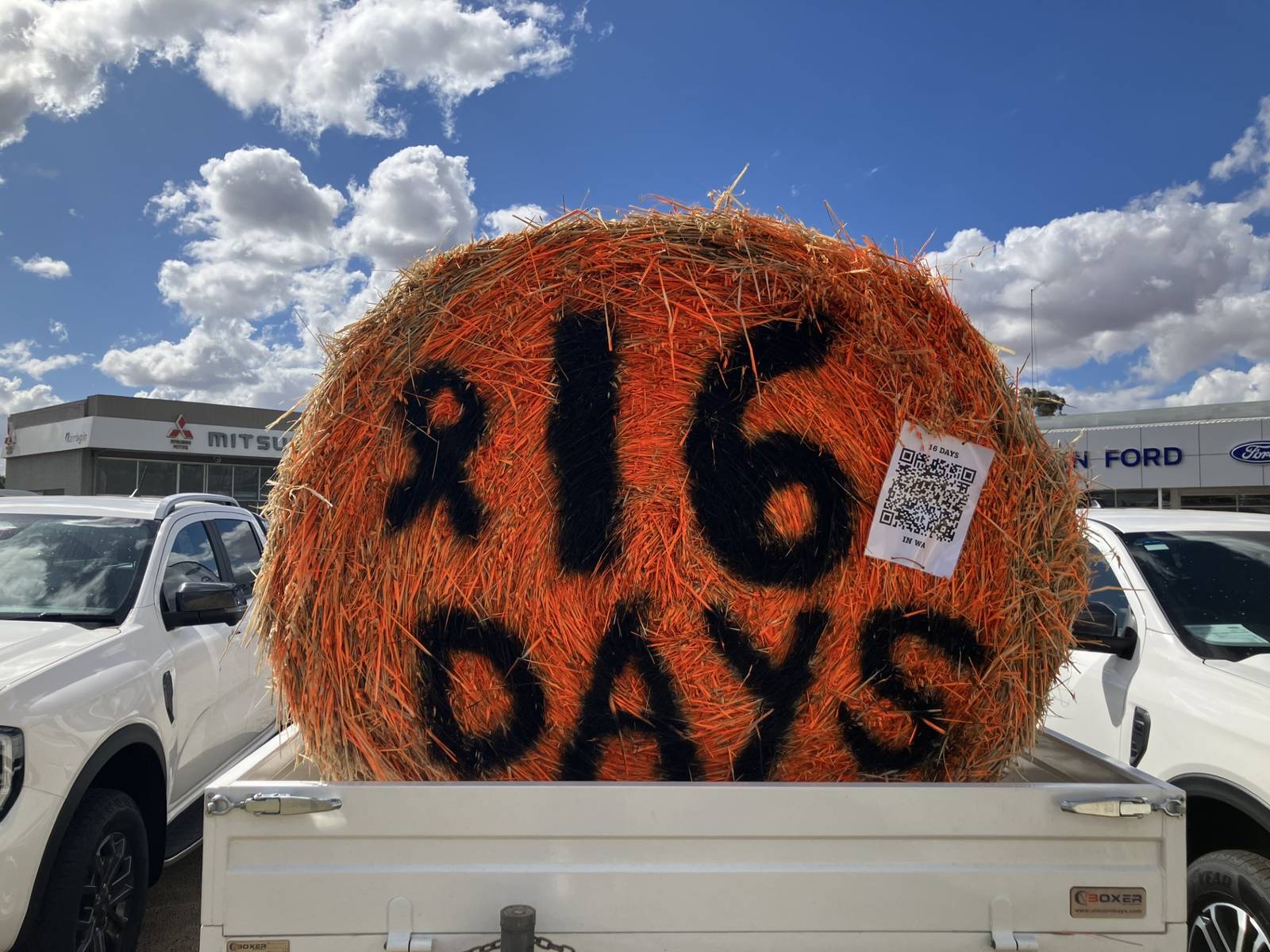 Large orange-painted hay bale marked “16 Days” displayed in the back of a ute in Narrogin, supporting the farming community’s involvement in the 16 Days in WA campaign.